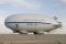 The hybrid airship demonstrator, known as P-791, is 123 feet long, fifty-three feet wide, and thirty feet high, was built in 2005. First flight came on 31 January 2006. All of the major components are attached on the outside of the envelope, which is woven Vectran, a lightweight, high-strength material similar to Kevlar. The engines and propellers are mounted on aluminum rings that allow vectoring up and down and left and right for climbing, descending, and steering. The engine, propeller, and engine mount combinations, called thrusters, give P-791 a top speed of about thirty knots.