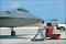 F-22 Raptor hot pitting at Andersen AFB, Guam, as a B-2 Spirit takes off in the background.